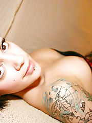 Photo 1, tattooed darkhaired showing breasts