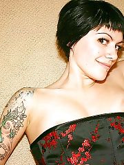 Photo 1, tattooed darkhaired showing breasts